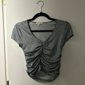 Blue cropped shirt with flowers.